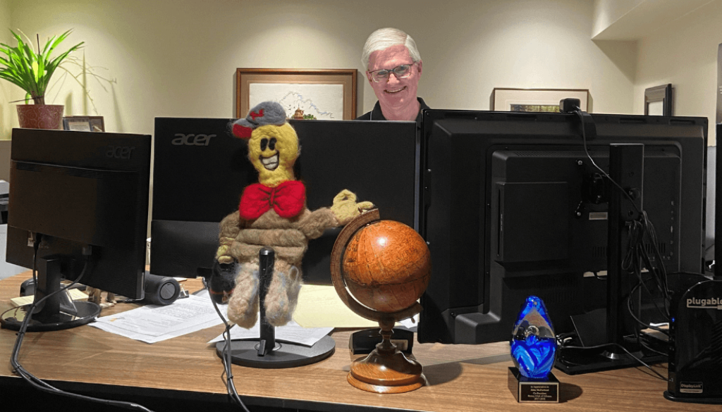 John McFarland standing behind Nu-Tek Electric's command centre smiling